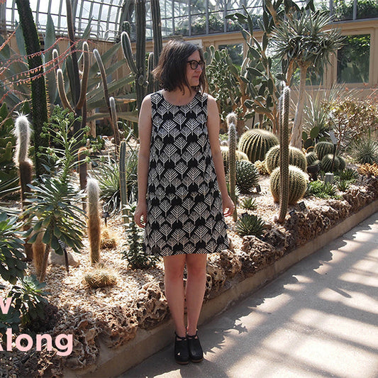 Willow Tank & Dress sewing pattern in black and white geometric print, sleeveless A-line dress worn in a greenhouse setting