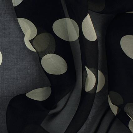 Black silk chiffon with large ivory polka dots draped to show fabric transparency and texture