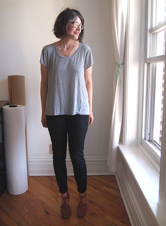 Woman wearing a gray Scout Tee in lightweight knit with short sleeves and relaxed fit, paired with black pants and tan wedges