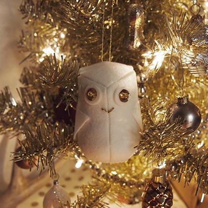 Grainline Snowy Owl Ornament: white felt owl with sequin and bead eyes, on gold tinsel tree with baubles