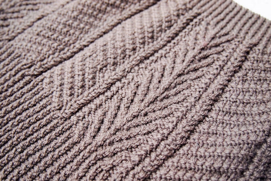 Close-up of mauve-brown cable knit High Pines Cowl by Brooklyn Tweed showing vertical raised texture lines