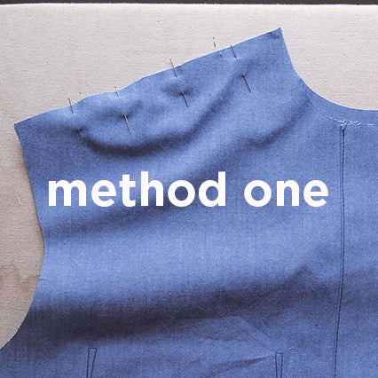 Blue chambray Archer Button-Up yoke pinned and ready for attachment using method one, with text overlay on a work surface