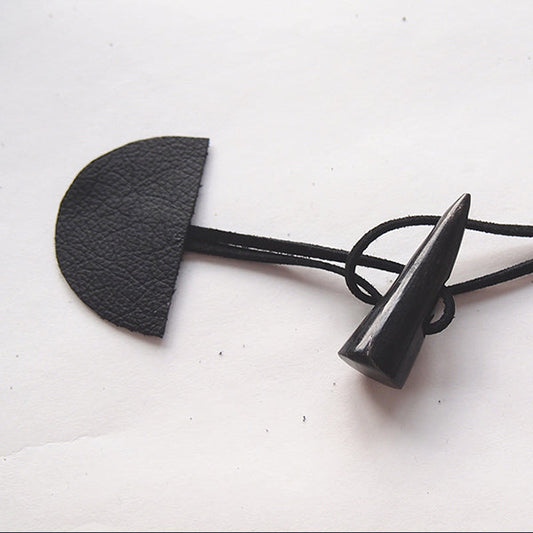 Black leather toggle closure with cord loop and wooden toggle for Cascade Duffle Coat hardware before attachment