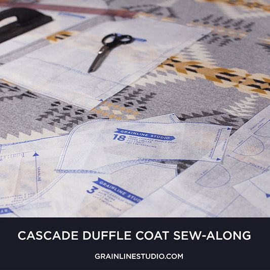 Cascade Duffle Coat sew-along pattern pieces laid out on Pendleton wool with scissors and Grainline Studio text overlay
