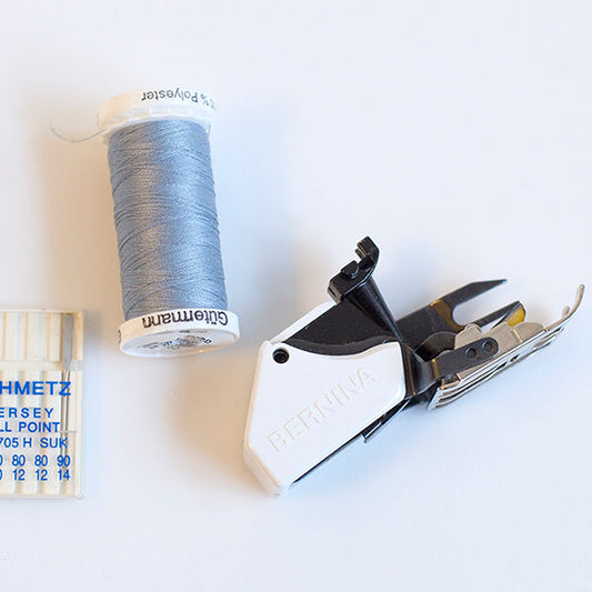 Sewing supplies for knit fabric projects: Gütermann thread, Schmetz ball point needles, and Bernina walking foot