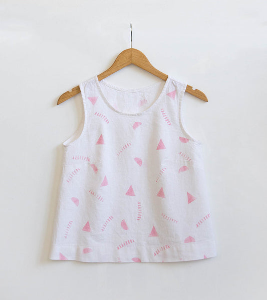 Willow Tank in white linen with hand potato-printed pink triangles and dashes, hanging on a wooden hanger