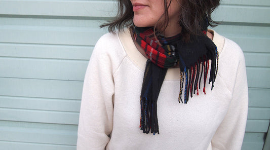 Linden Sweatshirt in cream with raglan sleeves and ribbed neckline, styled with plaid fringed scarf against blue siding