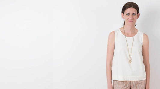 Willow Tank in cream with crew neckline, styled with Maritime Shorts and a long gold pendant necklace