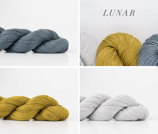 Shibui Knits Lunar yarn in four colorways: slate blue, golden yellow, light gray, and cream, displayed in twisted skeins
