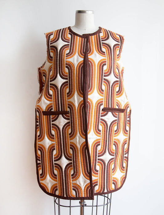Tamarack Jacket hack in cream and orange retro geometric print with brown binding, displayed on dress form with patch pockets