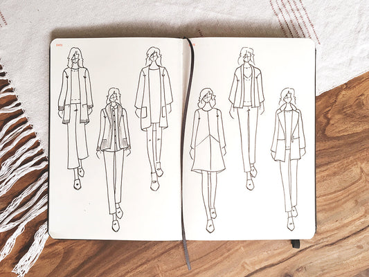 Open sketchbook on wooden surface showing six fashion illustration sketches including Farrow dress and Yates Coat designs