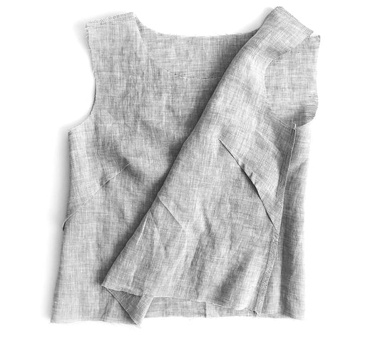 Uniform Tunic bodice pieces in light gray linen showing dart construction with pressed folds and stitched dart legs