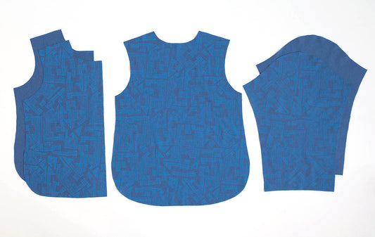 Tamarack Jacket sewing pattern pieces in blue geometric print fabric showing front, back, and sleeve components for shell and lining