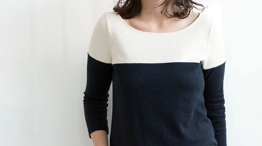 Lark Tee in cream and navy colorblock with three-quarter sleeves and boatneck, worn with dark jeans against a white wall