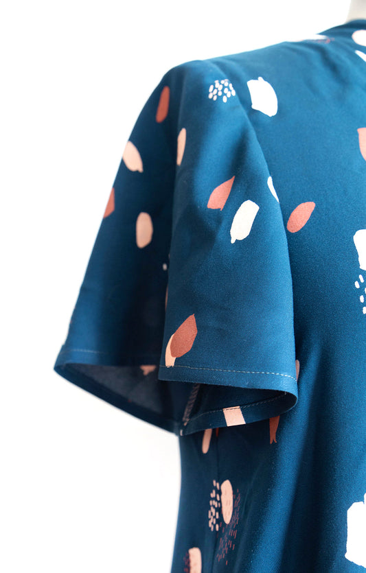 Felix Dress in teal abstract mark print, close-up of flutter sleeve construction and underarm seam detail on dress form