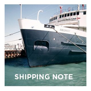 Large cargo ship docked at port with "SHIPPING NOTE" text overlay