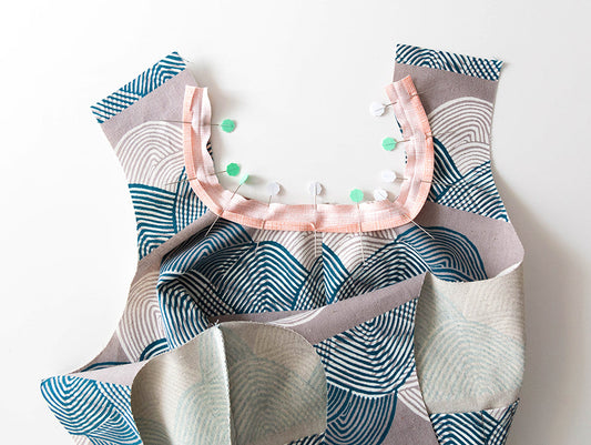 Inside-out Stowe Bag in teal wave print, pink bias tape pinned around inner handle edges showing bias tape application