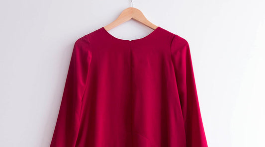 Farrow Dress in deep red silk crepe de chine on wooden hanger, back view showing center seam