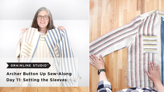 Archer Button Up Sew-Along Day 11: Setting the Sleeves, striped shirt held up and hands positioning sleeve on wood table