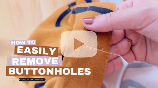 Grainline Studio video: hand removing buttonhole from orange and black print fabric, titled How to Easily Remove Buttonholes