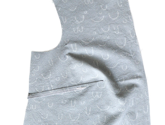 Sewing the Farrow 14-32 Darts: gray fabric bodice showing serged dart takeup, wrong side of white printed fabric