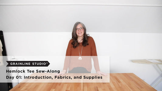 Hemlock Tee Sew-Along Day 01: Introduction, Fabrics, and Supplies, with person wearing rust Hemlock Tee at wood table
