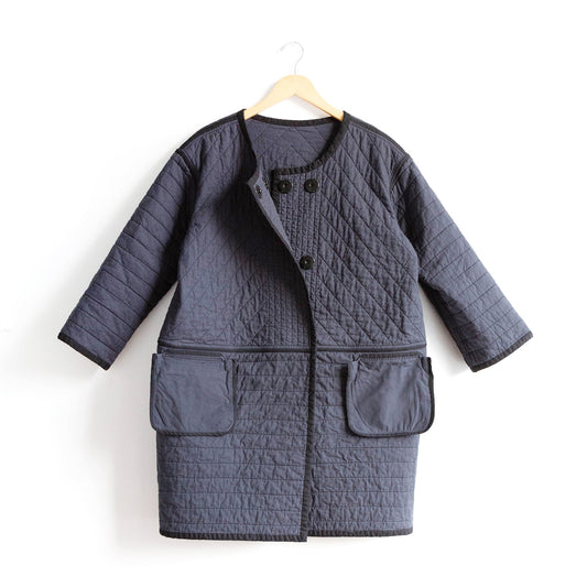 Modified Tamarack Jacket in charcoal quilted cotton shown inside out, three-quarter sleeves, round neckline, pocket bags