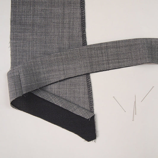 Morris Blazer facing pieces in gray and black fabric showing graded seam allowance and serged edge finish with sewing pins