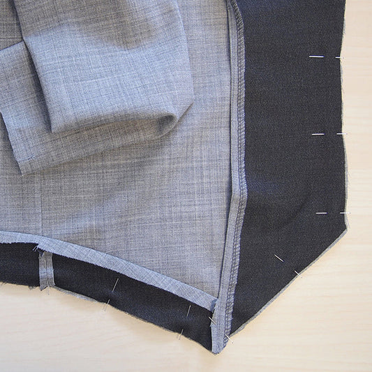Morris Blazer gray shell with black facing pinned to front and back pieces, showing seam allowances and fabric alignment