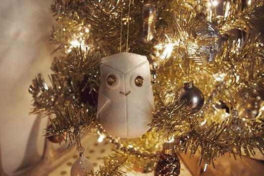 Grainline Snowy Owl Ornament: white felt owl with sequin and bead eyes, on gold tinsel tree with baubles