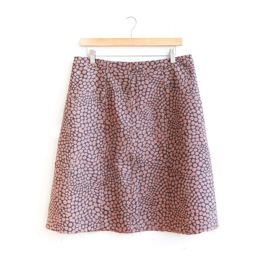 Reed Sew-Along: Views A & B, showing dusty pink abstract dot skirt with flat waistband and unfinished hem on wooden hanger