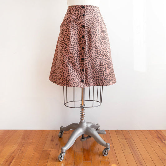 Reed Skirt in dusty pink and gray abstract dot print with button-front closure, displayed on dress form