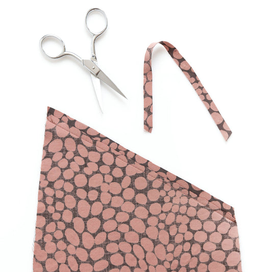 Reed Skirt View A pocket showing graded seam allowance on dusty pink abstract dot fabric, with scissors and seam strips