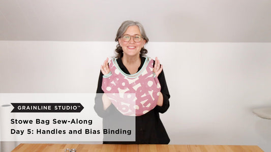 YouTube thumbnail for Stowe Bag Sew-Along Day 5: Handles and Bias Binding, woman holding mauve printed bag with mint binding