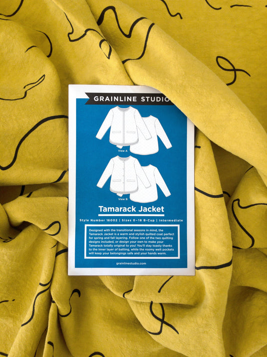Grainline Studio Tamarack Jacket pattern envelope, Style 16002, Sizes 0-18 B-Cup, on mustard yellow linen fabric