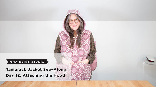 YouTube thumbnail for Tamarack Jacket Sew-Along Day 12: Attaching the Hood, woman wearing pink quilted vest with hood up