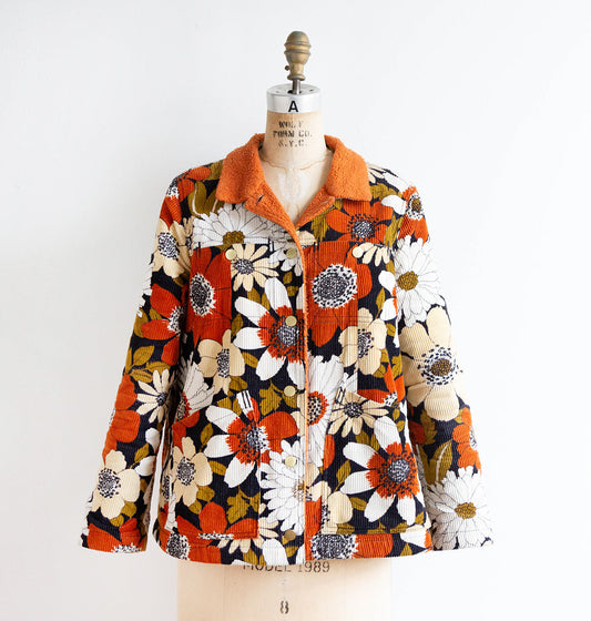 Thayer Jacket in vintage retro daisy print corduroy with orange sherpa collar and brass buttons, on dress form