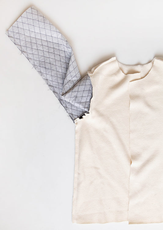 Thayer Sew-Along: Assembling the Lining, showing wrong sides of cream sherpa and pre-quilted lining fabric with diamond grid