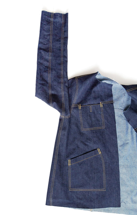 Thayer Jacket in dark indigo denim showing set-in sleeve and armscye seam detail with topstitching and patch pockets