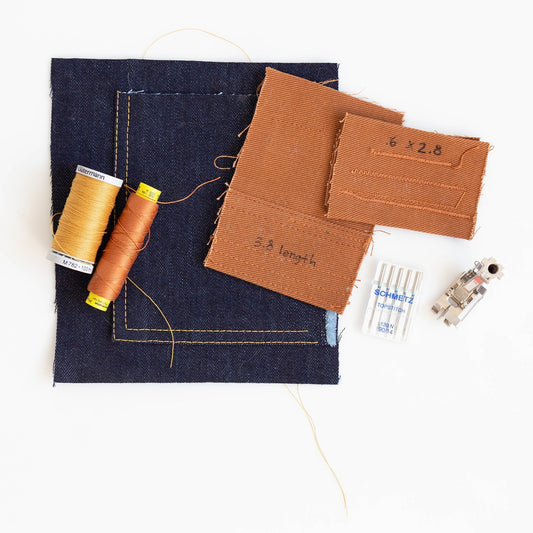 Thayer Jacket topstitching supplies: navy denim sample, Gutermann thread spools, brown fabric test pieces, and Schmetz needles