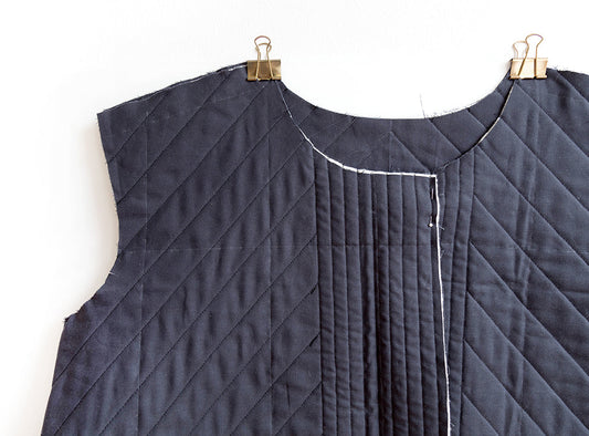 Hacked Tamarack Jacket front panel in navy quilted fabric with diagonal and vertical quilting lines, hung with binder clips