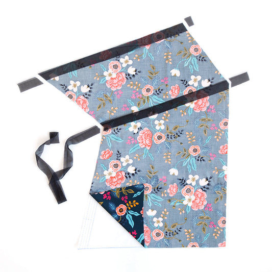 Farrow Dress front pattern pieces with floral print fabric showing interfacing strips and pocket markings for assembly
