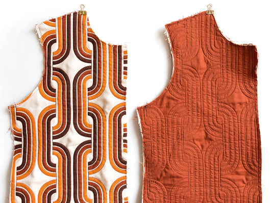 Tamarack Jacket front piece: right side in orange and brown geometric print, wrong side showing rust free-motion quilting