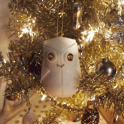 Grainline Snowy Owl Ornament: white felt owl with sequin and bead eyes, on gold tinsel tree with baubles