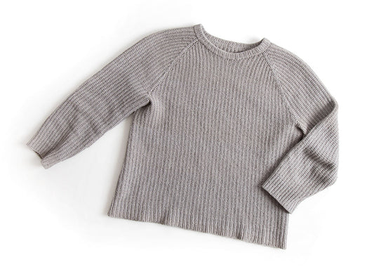 Handknit gray half fisherman's rib pullover with raglan sleeves and crew neck, displayed flat on white background