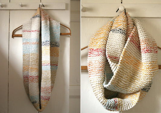 Two views of a garter stitch cotton cowl with cream, gold, red, and gray stripes on a wooden hanger against white shiplap