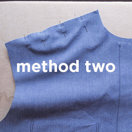 Blue chambray Archer Button-Up yoke pinned and ready for attachment using method two, with text overlay on a work surface