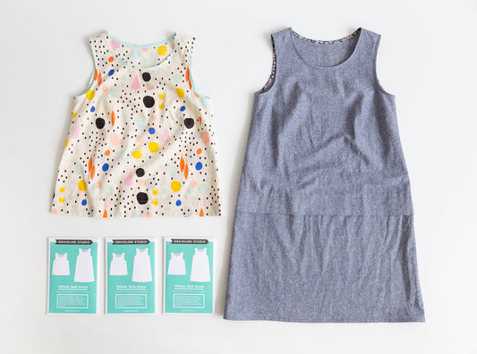 Willow Tank and Dress in colorful abstract print and blue chambray, displayed with three Grainline Studio pattern envelopes
