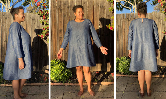 Farrow Dress in blue chambray-look fabric, shown from side, front, and back on model outdoors by wooden fence