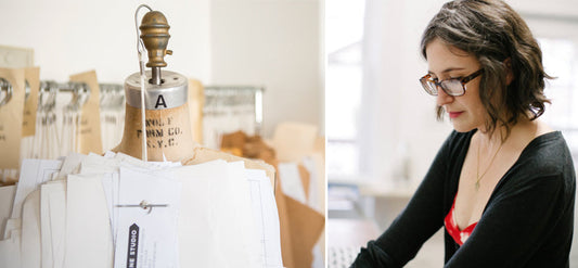 Vintage dress form with pattern pieces in a sewing studio, alongside a woman in glasses reviewing pattern drafting materials